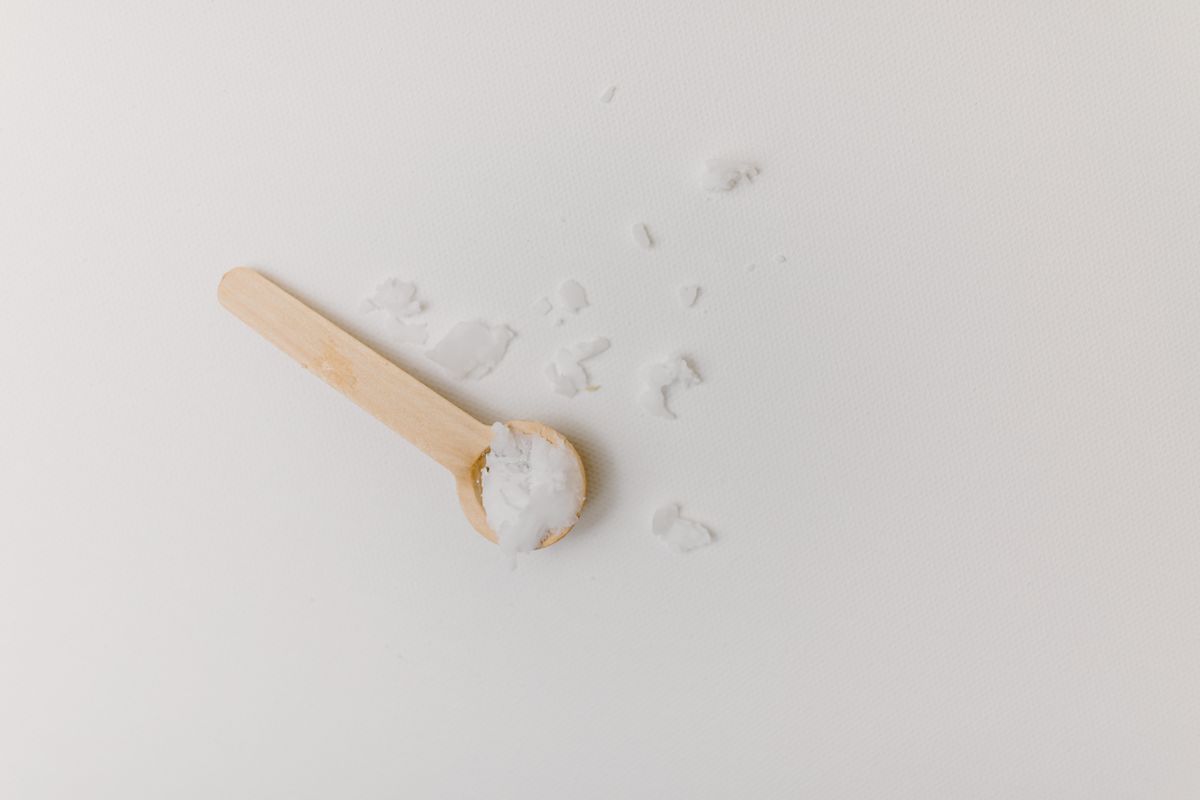 Bath salt crystals in a small wooden scoop