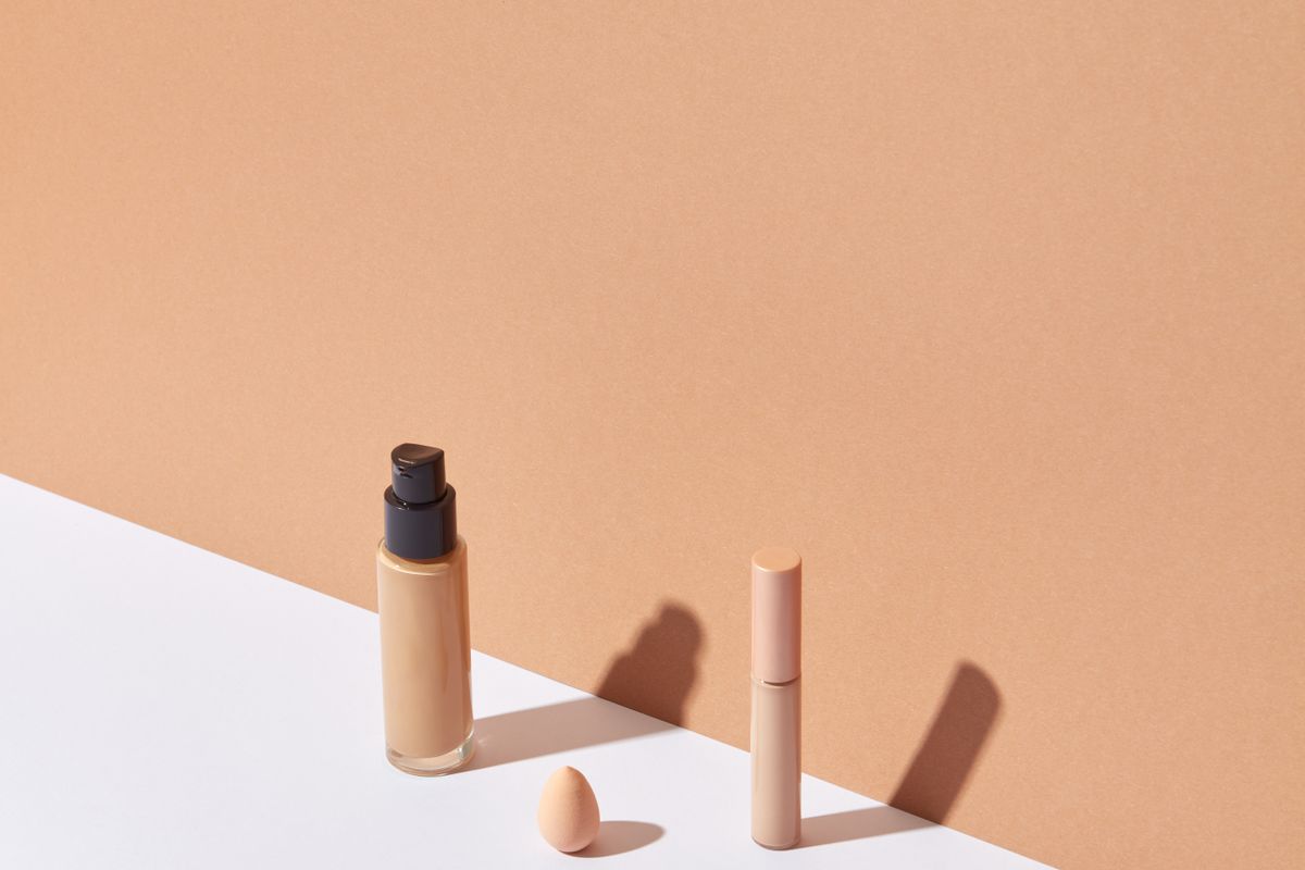 A lipstick bullet on a white and beige background