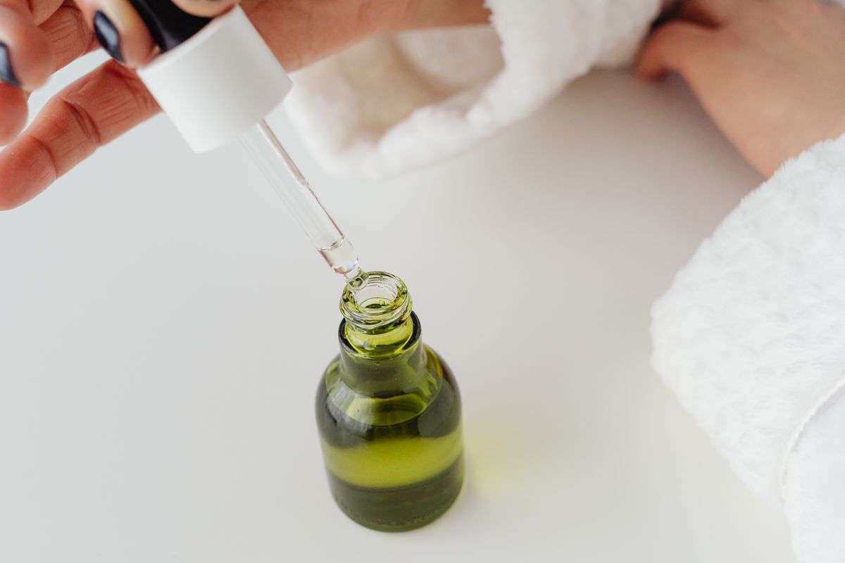 Amber dropper bottle of vitamin C serum with colored liquid inside